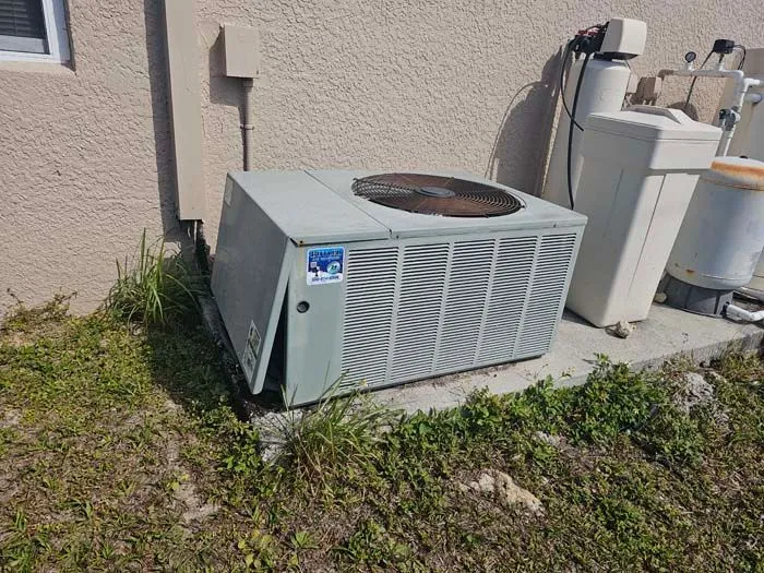 New packaged HVAC unit installed on a concrete slab beside a home in Punta Gorda, FL