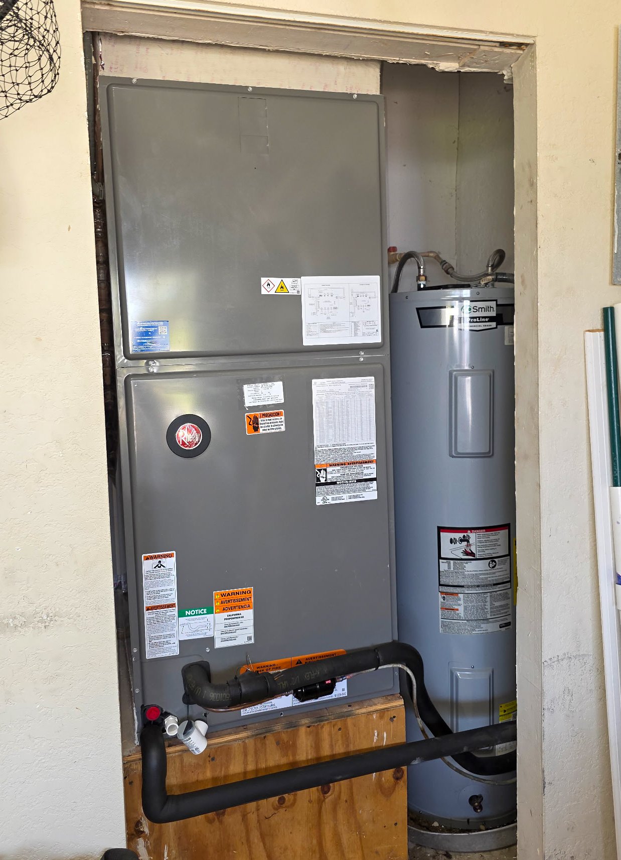 New Rheem air handler installed in a residential closet beside an A.O. Smith water heater in Punta Gorda, FL