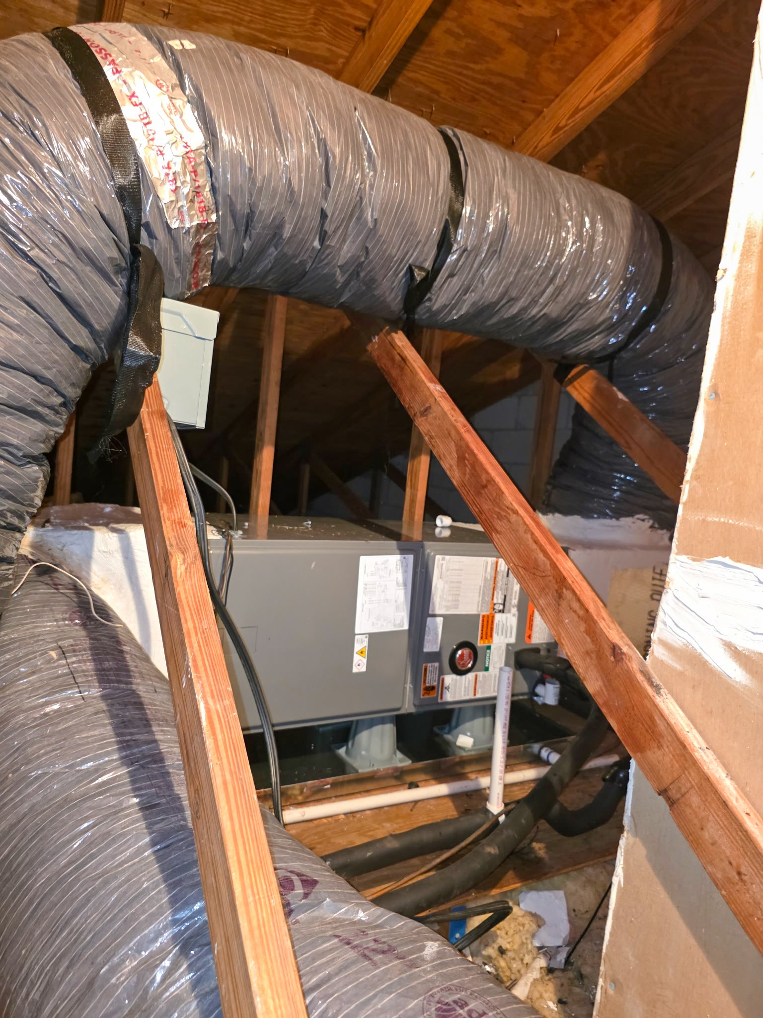 Attic air handler and flexible ductwork installed during a residential AC replacement in Punta Gorda, FL